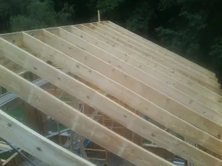 New roof rafters set over an addition before sheathing in Mount Laurel