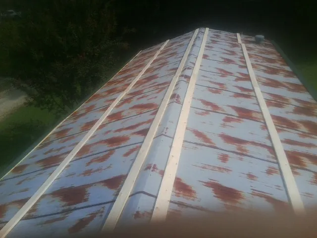 Rusted metal roof panels with new wood purlins before replacement — Storm Damage Roof Repair in Mount Laurel by Roofing Brothers